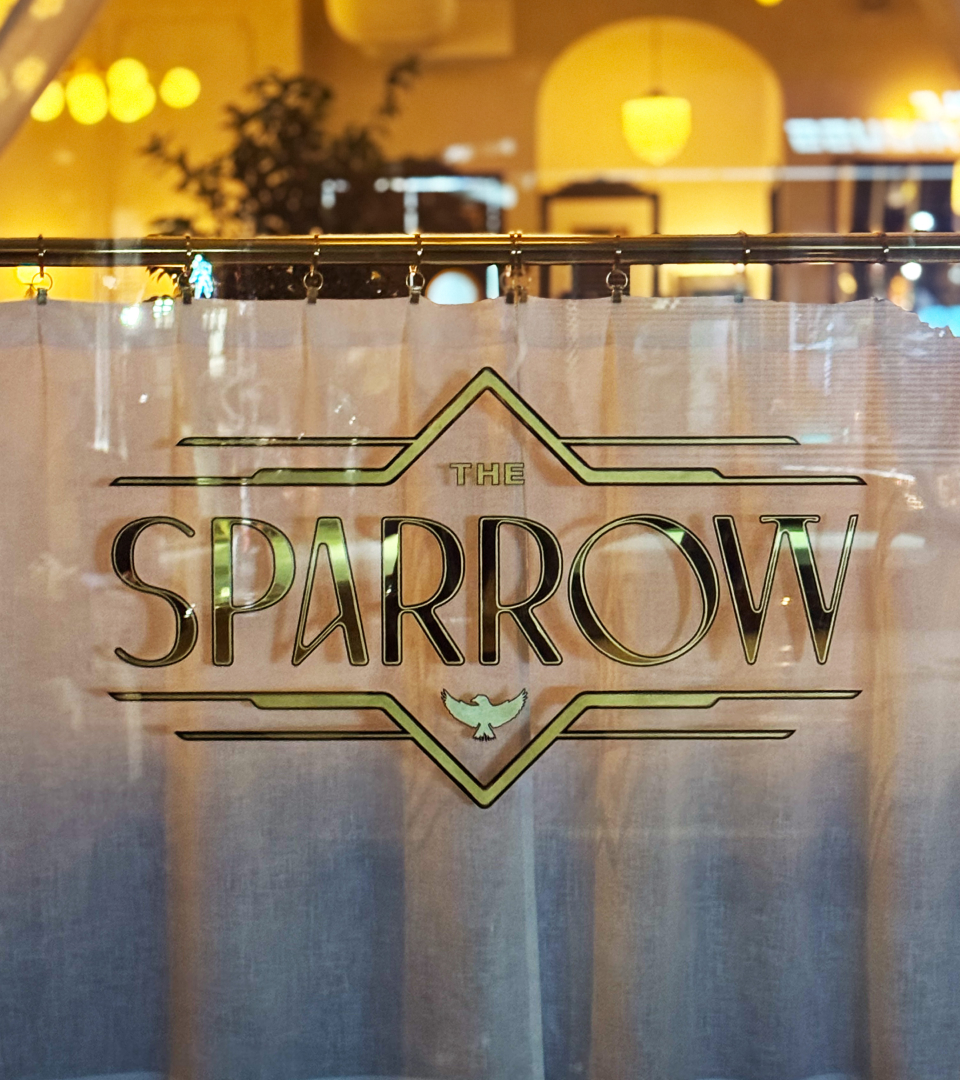 Photo of sparrow logo on window